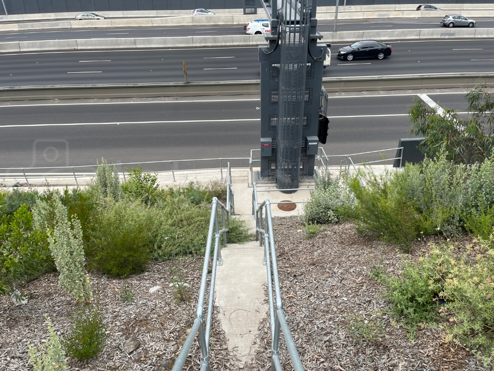 Steel tube clamp handrail installed either side of highway access steps